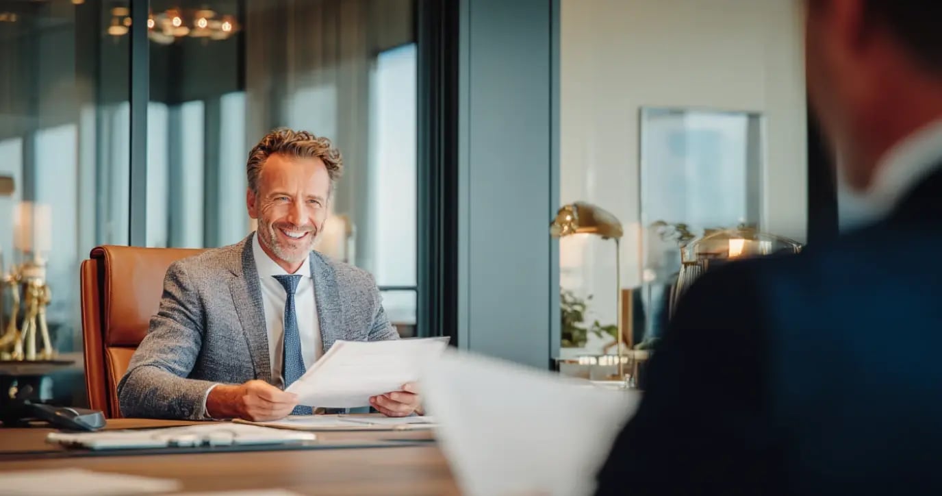 Professional wealth advisor reviewing documents with client in modern office setting
