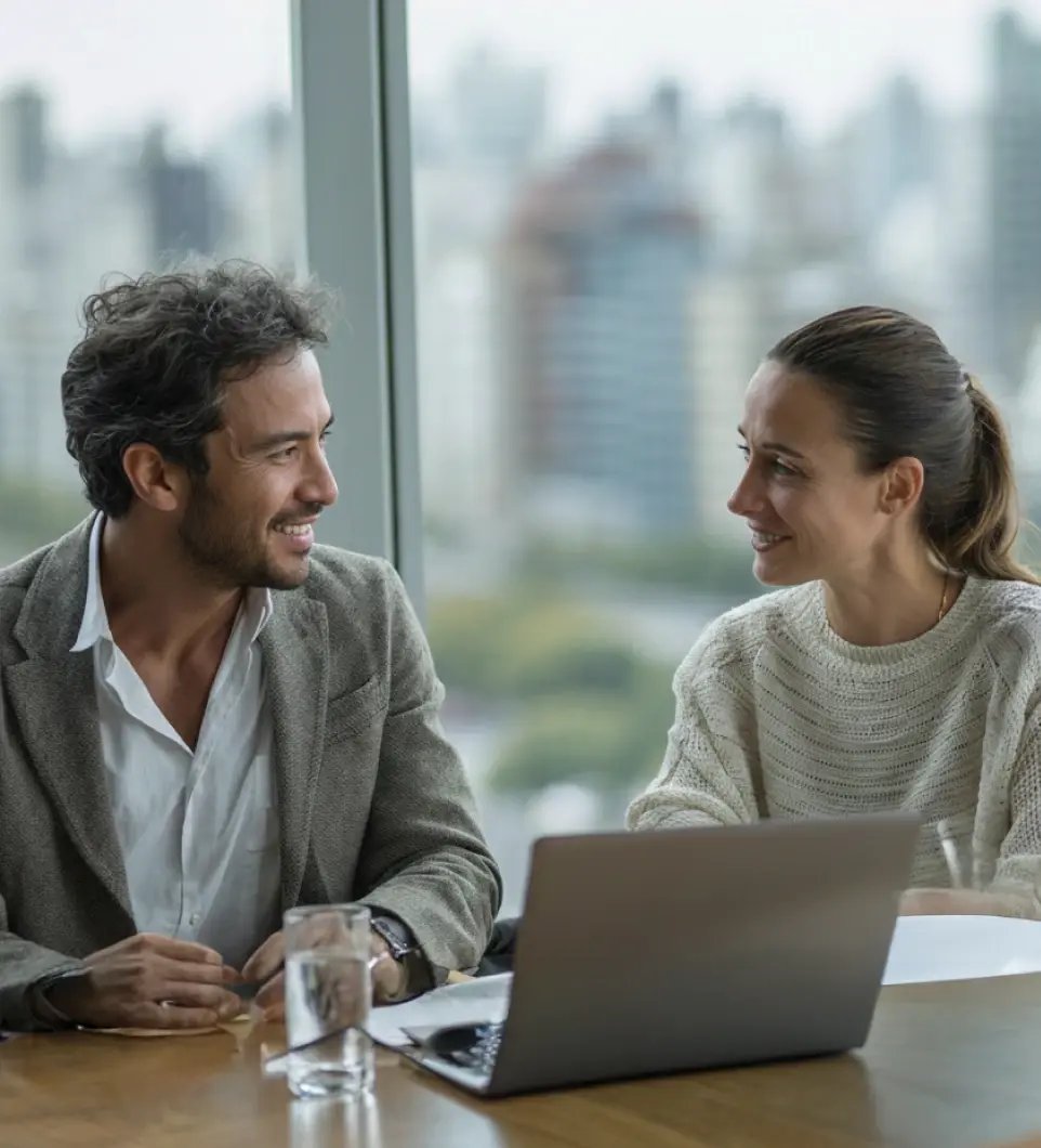 Two business professionals collaborating on fund management services at modern office with city skyline
