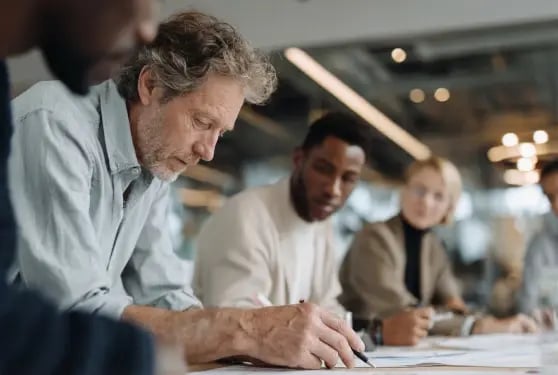 Professional team collaborating on corporate services and business strategy in modern office setting