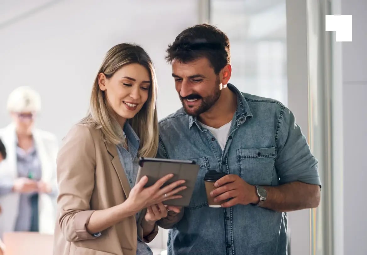 Business professionals reviewing trademark registration documents on tablet in modern office