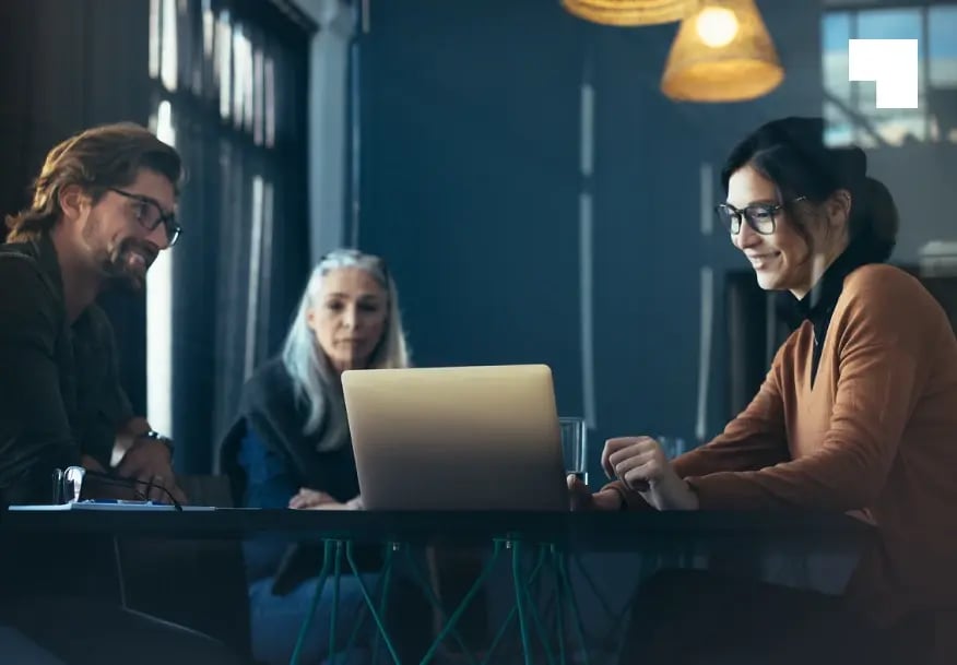Three professionals collaborating at a modern office meeting to discuss business insolvency and restructuring solutions